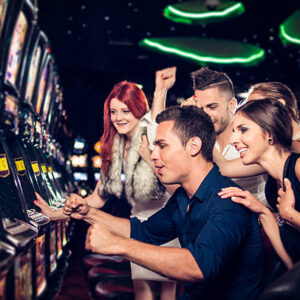 Group of people playing slot machines