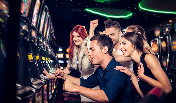 Group of people playing slot machines