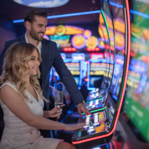 handsome couple having fun and drinking wine at casino