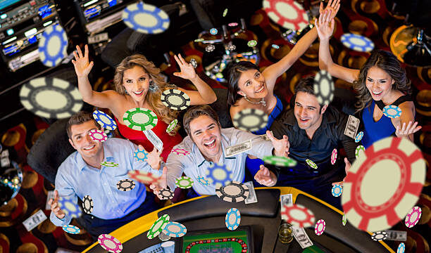 Happy group of people winning at the casino