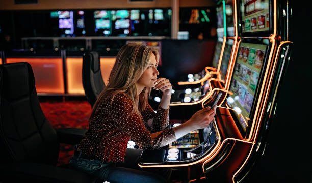 Women gambling on slot machinery