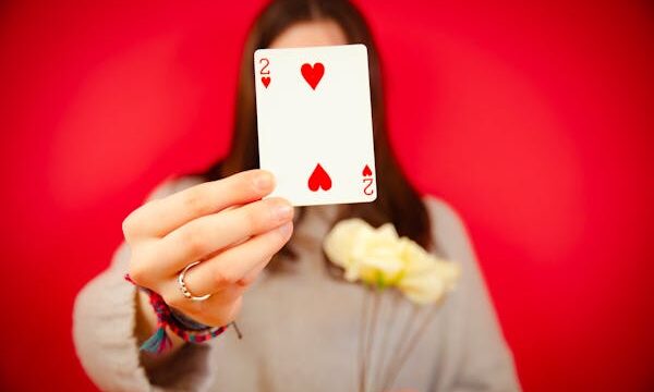 free-photo-of-woman-holding-a-two-of-hearts-card